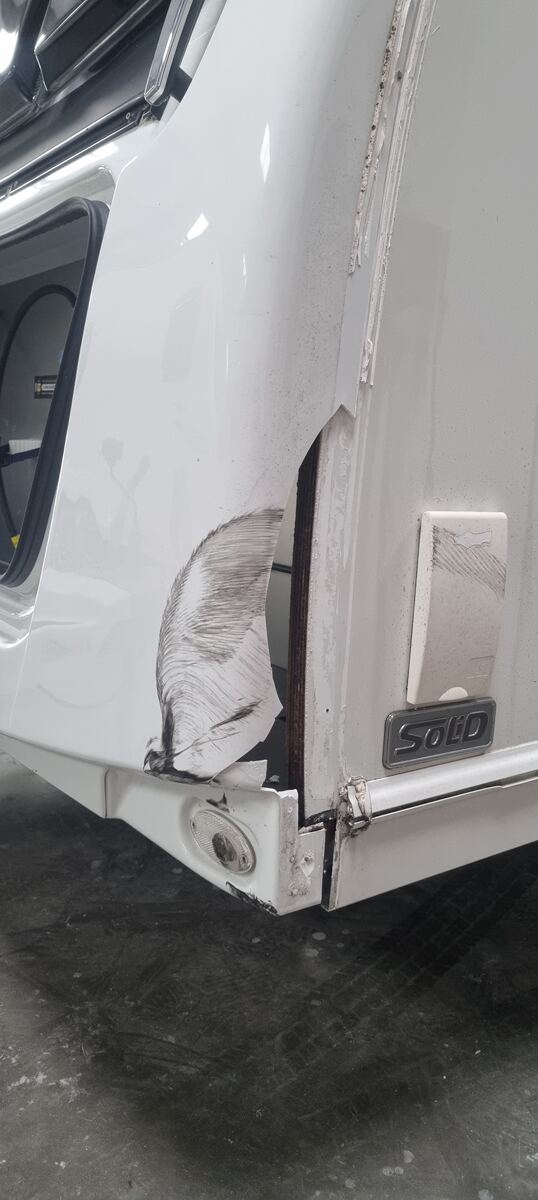 Caravan corner damage before repair