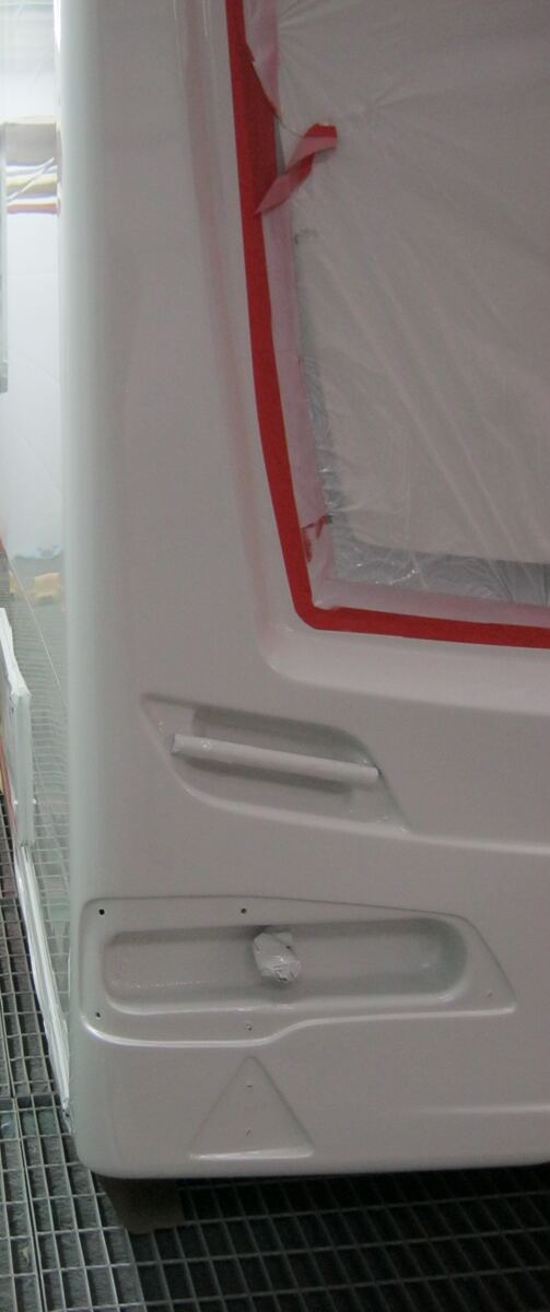 Rebuilt caravan rear end masked for refinishing